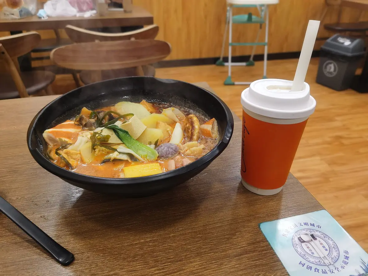 赤いスープに野菜やきのこ、湯葉などの具材がたっぷり入った麻辣湯の器